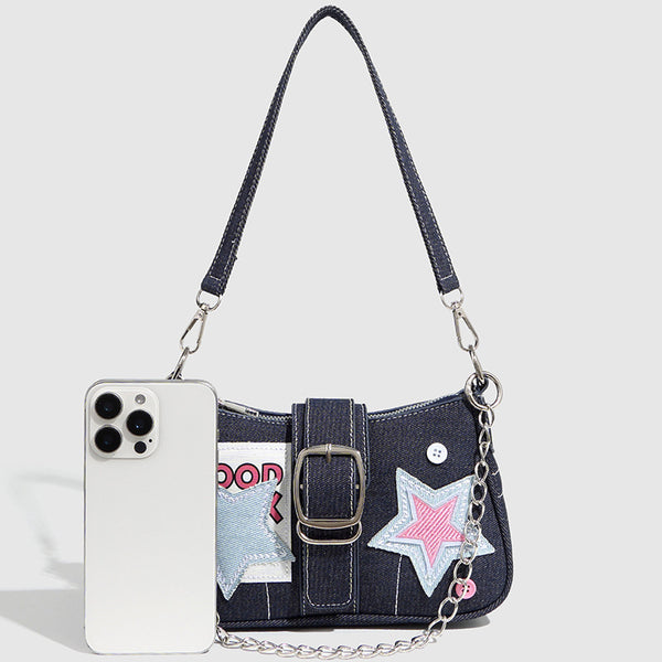 Dark navy denim-look shoulder bag with light blue and pink star appliqués, silver-tone buckle, chain strap, and short top