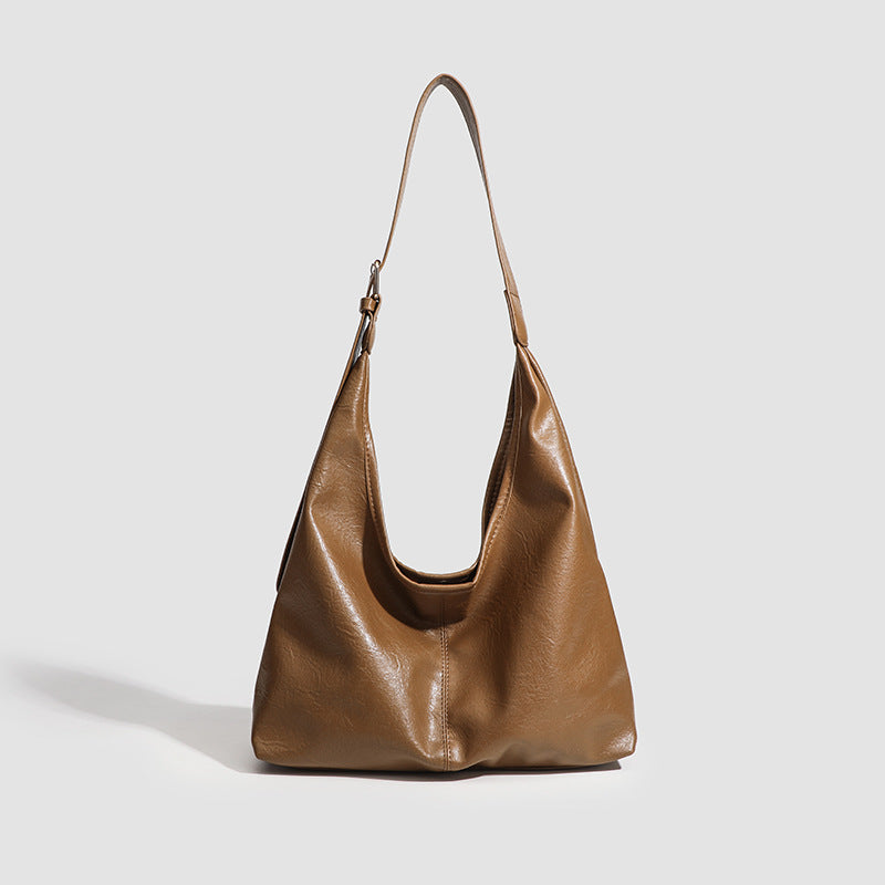Large slouchy hobo shoulder bag in smooth leather-look finish with adjustable strap and gold-tone hardware, detail view 9