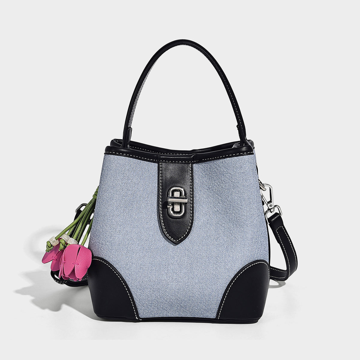 Small structured bucket bag in denim-look light blue fabric with black leather-look trim, silver turn-lock hardware, short