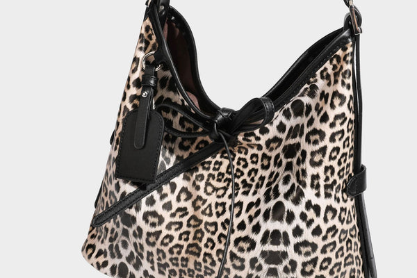 Slouchy leopard print shoulder hobo bag with black leather-look trim, tie-top closure, and single long strap, detail view 32