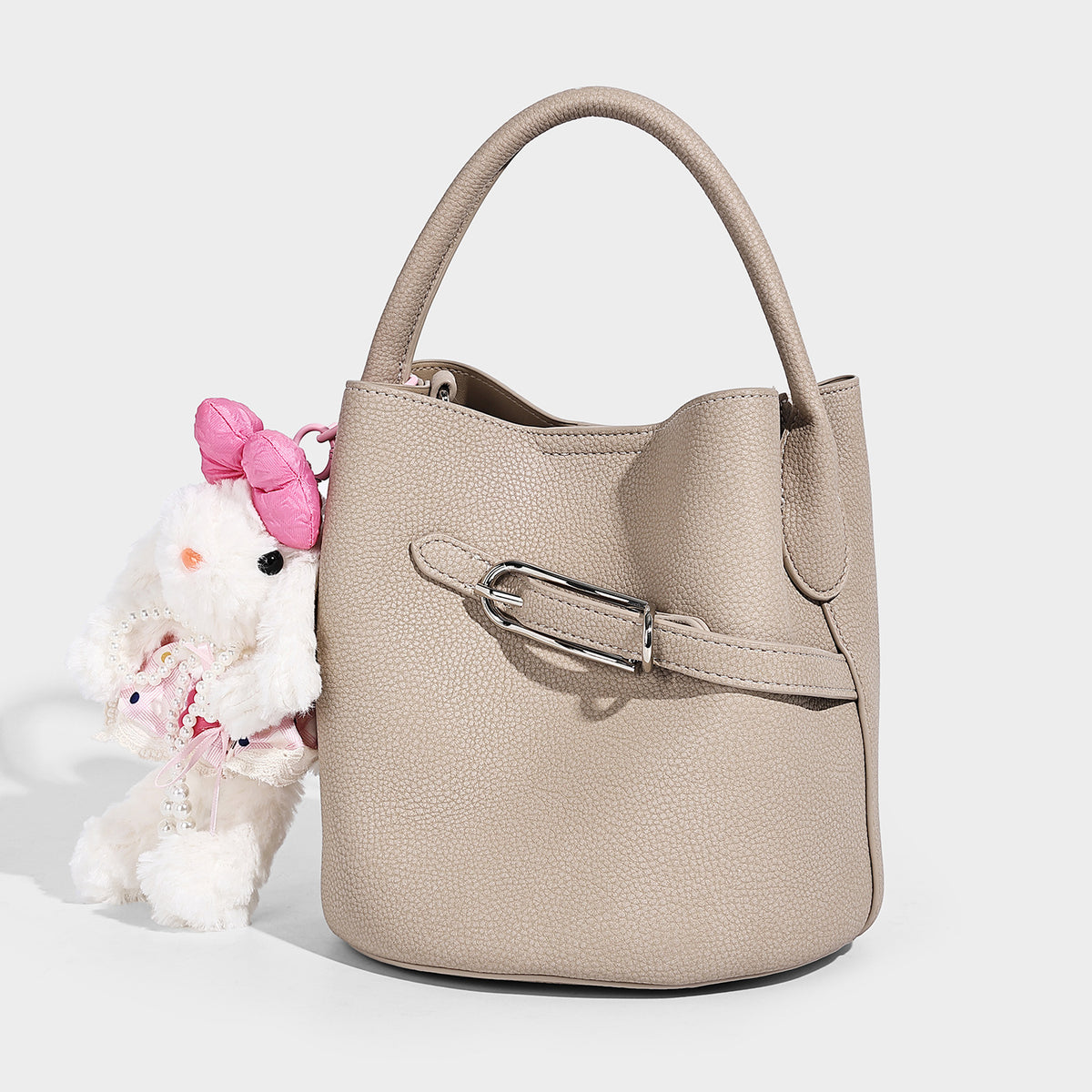 Mini pebbled leather-look bucket bag with front buckle strap, silver-tone hardware, top handle, and detachable shoulder