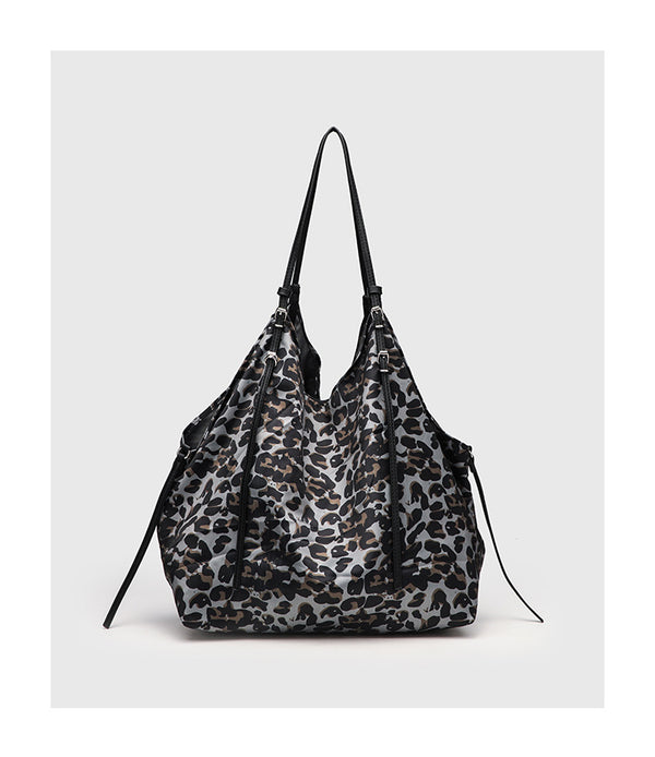 Large leopard-print slouchy tote shoulder bag in grey, black, and tan with gold-tone hardware and adjustable leather-look