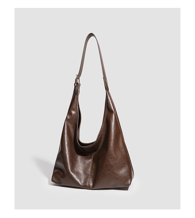 Large slouchy hobo shoulder bag in smooth leather-look finish with adjustable strap and gold-tone hardware, detail view 12