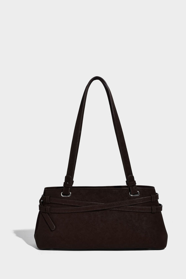 Structured trapezoid shoulder tote in dark brown matte suede-look finish with dual straps, wraparound belt bands