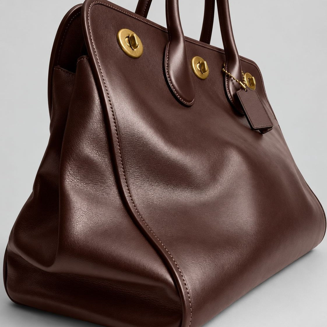 Structured leather-look tote bag with three gold-tone turn-lock closures and double rolled top handles, detail view 3