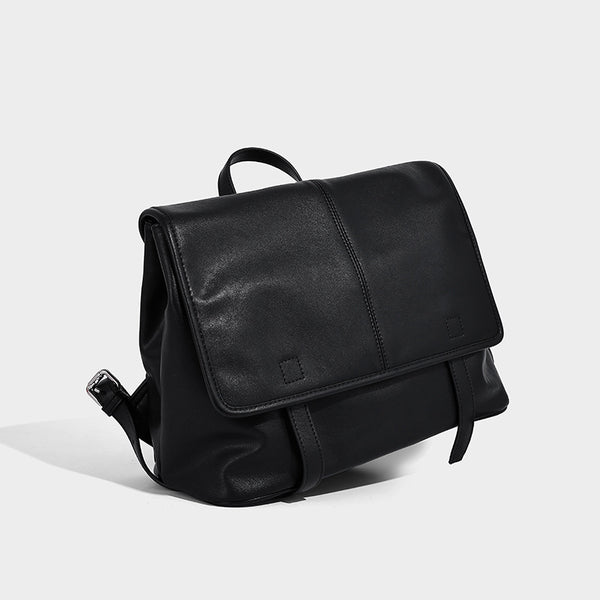 Structured tan leather-look flap backpack handbag with top handle, silver buckle hardware, and fold-over front closure