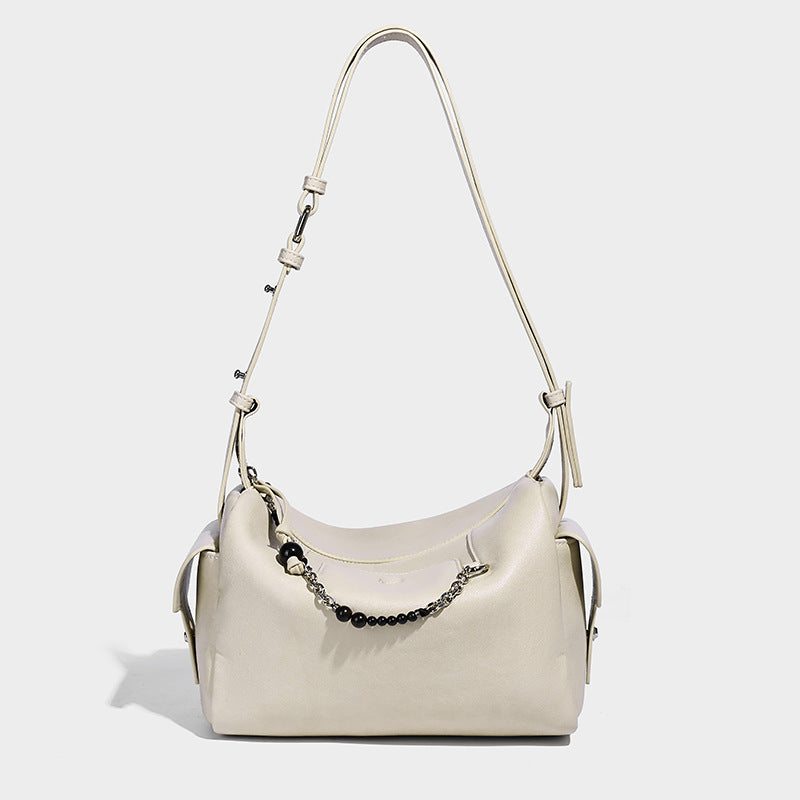 Small slouchy moto-style crossbody bag in smooth matte leather-look finish with white contrast stitching, silver-tone, detail