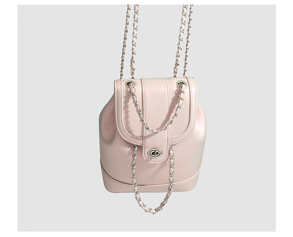 Small pearl-gloss backpack handbag with woven silver chain straps and turn-lock flap closure, detail view 10