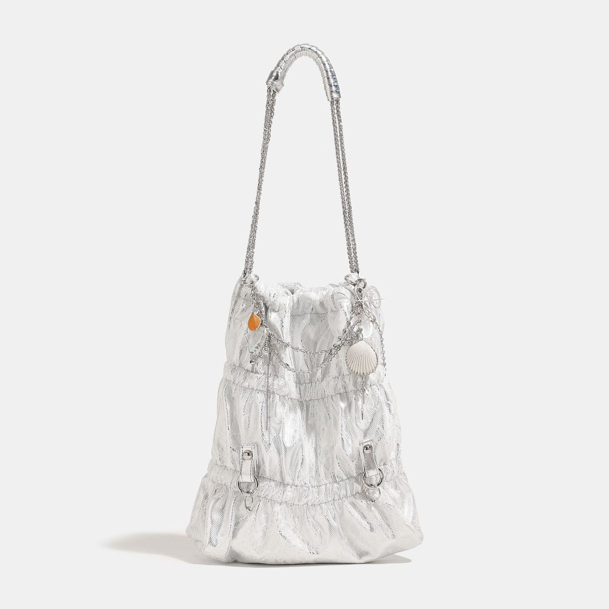 Slouchy lace-overlay bucket bag with silver chain strap, draped chain detail, shell charms, and drawstring top closure