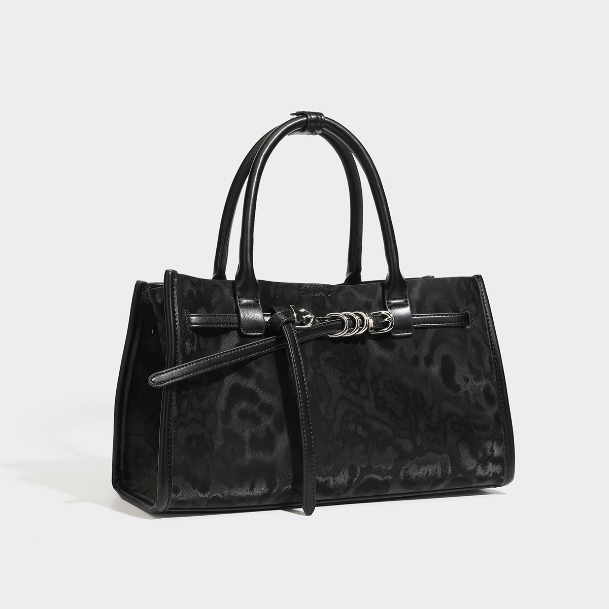Structured leopard-print tote bag with glossy satin-like finish, dual rounded top handles, silver buckle-and-ring front