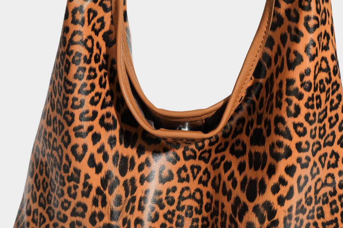 Glossy leopard-print slouchy shoulder bag with long strap and detachable tan zip pouch, detail view 27
