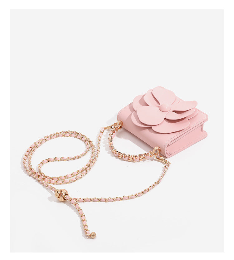 Small structured rectangular crossbody bag with layered 3D flower appliqué and gold-tone chain strap, detail view 17