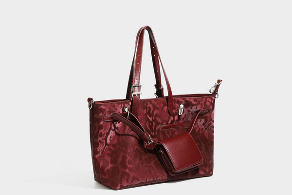 Glossy leopard-print tote bag with leather-look dark trim, dual top handles, detachable shoulder strap, and attached front