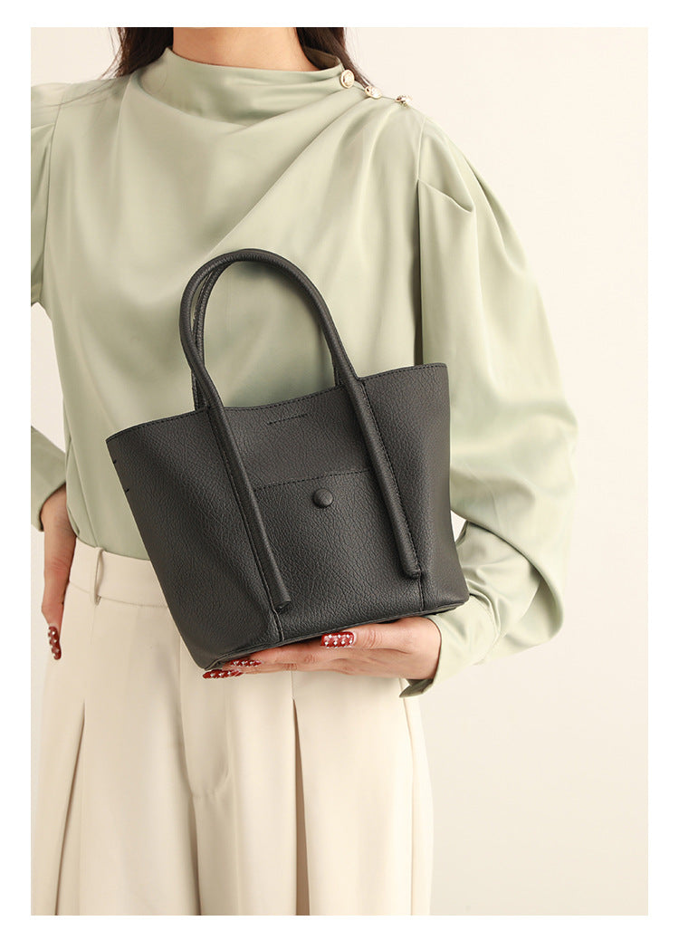 Structured pebbled matte tote bag with front snap pocket, dual top handles, and detachable zip pouch in almond beige, detail