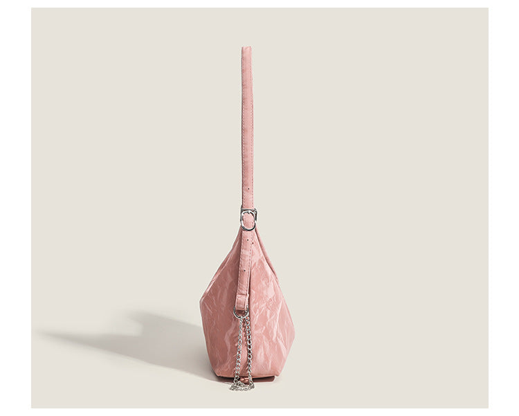 Blush pink slouchy hobo bag with crinkled sheen finish, silver-tone chain hardware, and adjustable shoulder strap, detail