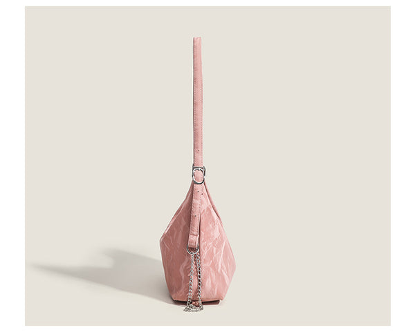 Blush pink slouchy hobo bag with crinkled sheen finish, silver-tone chain hardware, and adjustable shoulder strap, detail
