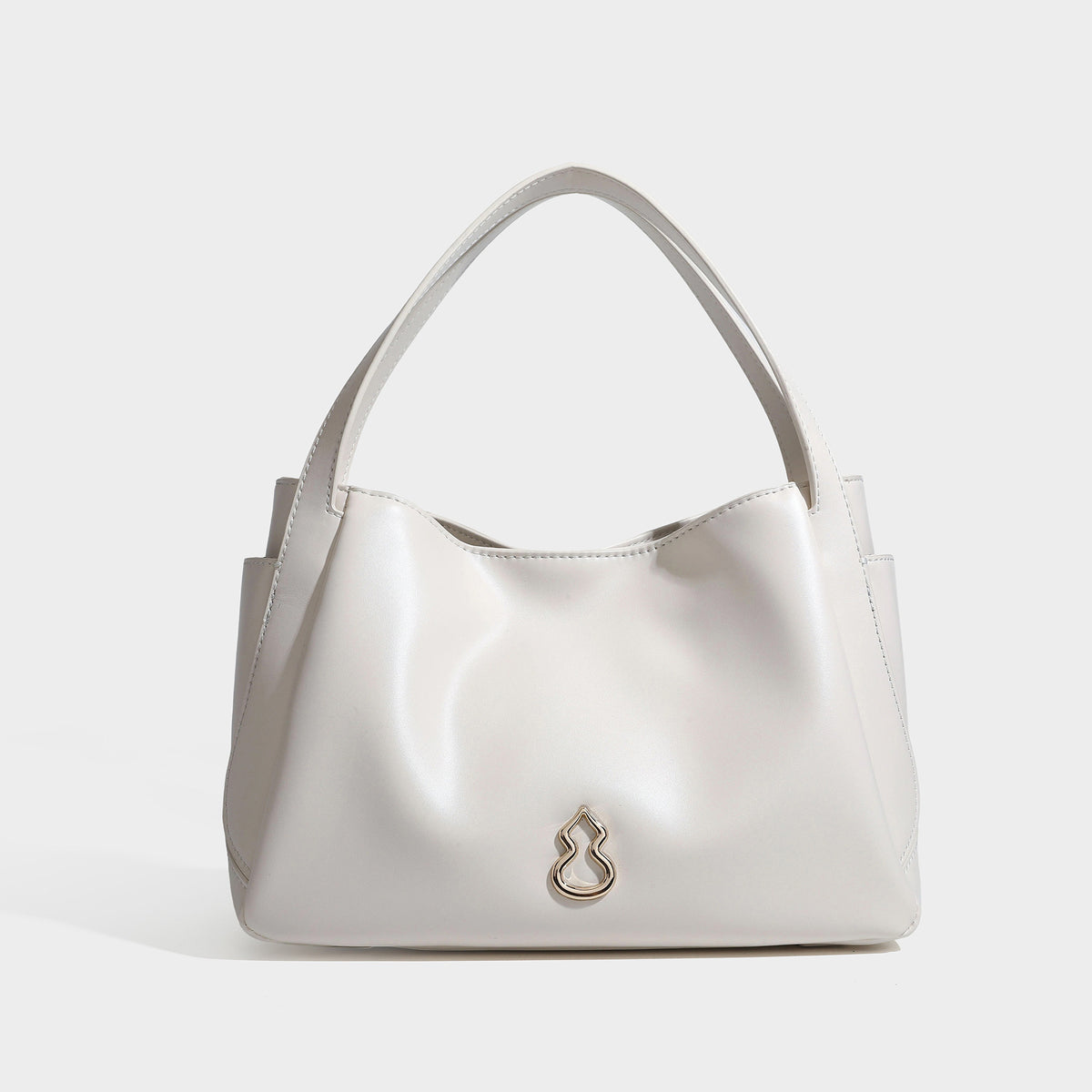 Structured glossy leather-look tote shoulder bag with dual top handles, detachable crossbody strap, side pockets, and, detail