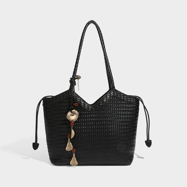 Woven tote bag with braided shoulder straps, drawstring closure, and dangling metal-and-bead charm, detail view 11