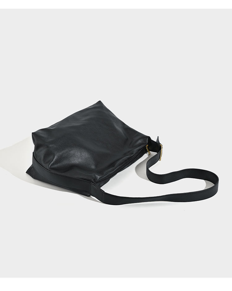 Large slouchy hobo shoulder bag in smooth black leather-look finish with gold-tone buckle hardware and adjustable strap