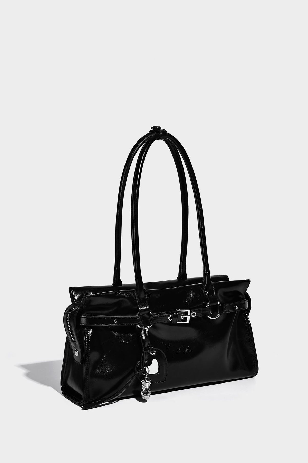 Structured rectangular glossy tote shoulder bag with belt buckle front strap and dangling charm hardware, detail view 9