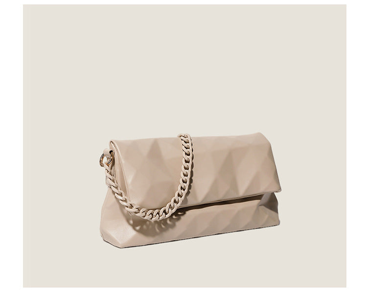 Cream white rectangular flap shoulder bag with geometric faceted surface and chunky tone-on-tone chain strap with gold-tone