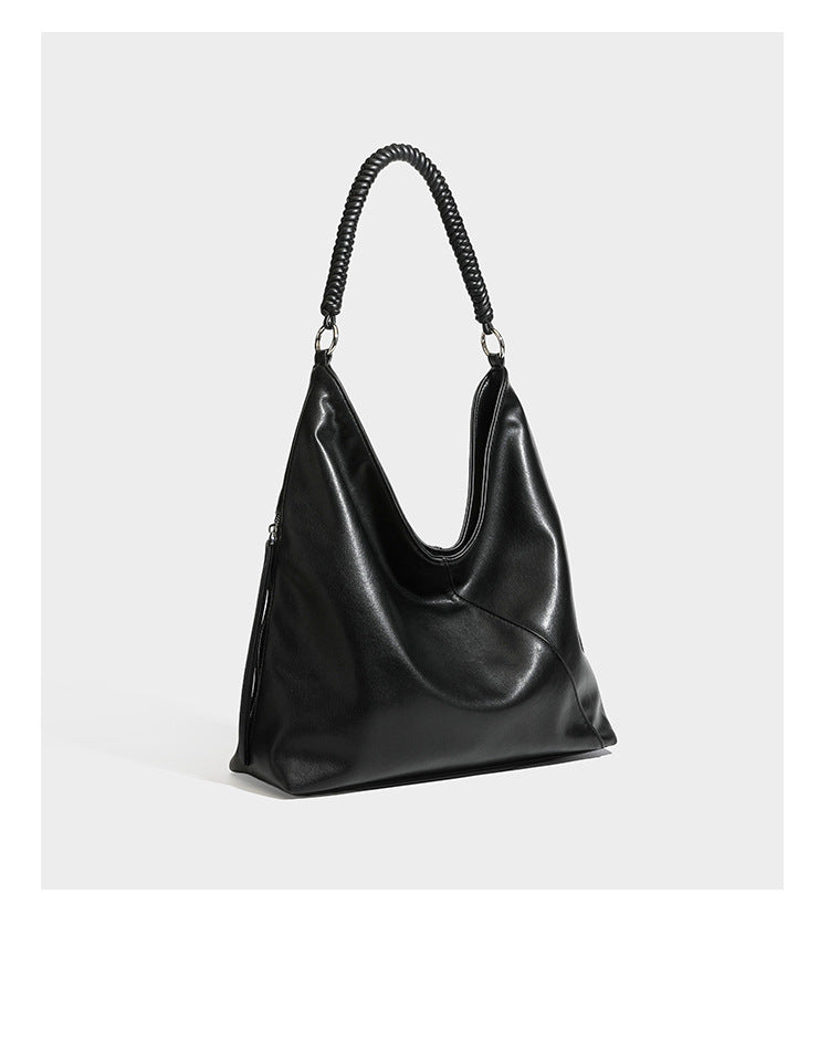 Large slouchy hobo shoulder bag with braided top handle, smooth glossy leather-look finish, and silver-tone ring hardware