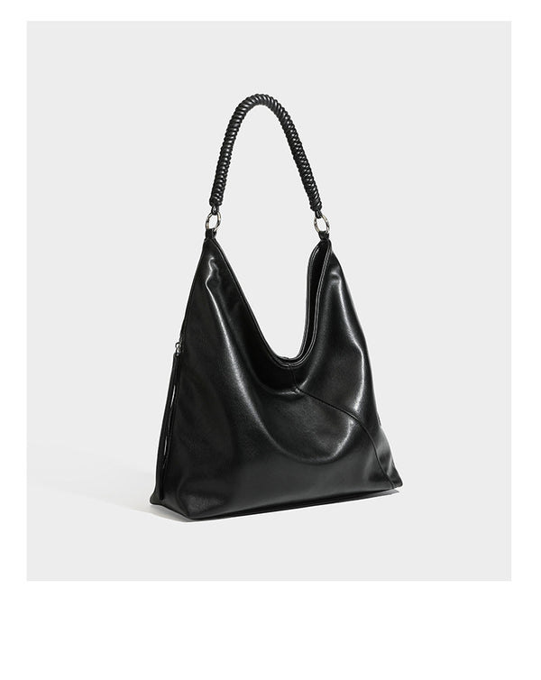 Large slouchy hobo shoulder bag with braided top handle, smooth glossy leather-look finish, and silver-tone ring hardware