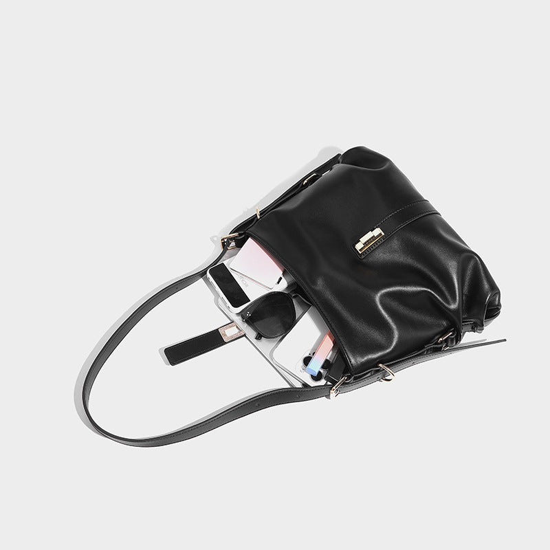 Soft slouchy hobo shoulder bag with smooth leather-look finish, gold-tone buckle and tab hardware, and long adjustable strap