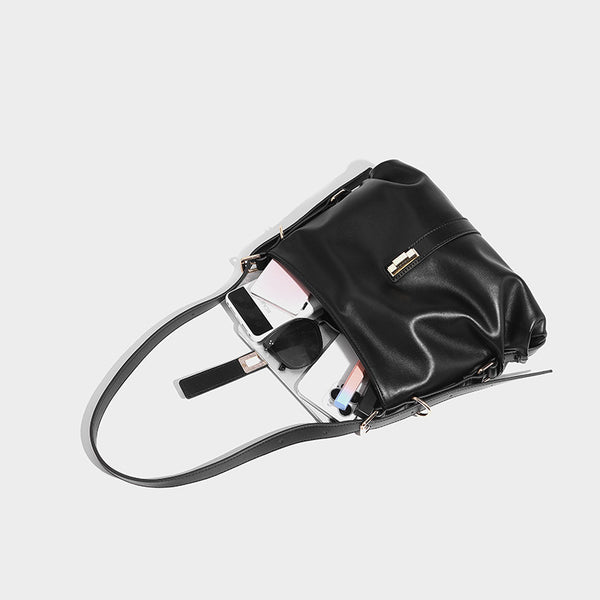 Soft slouchy hobo shoulder bag with smooth leather-look finish, gold-tone buckle and tab hardware, and long adjustable strap