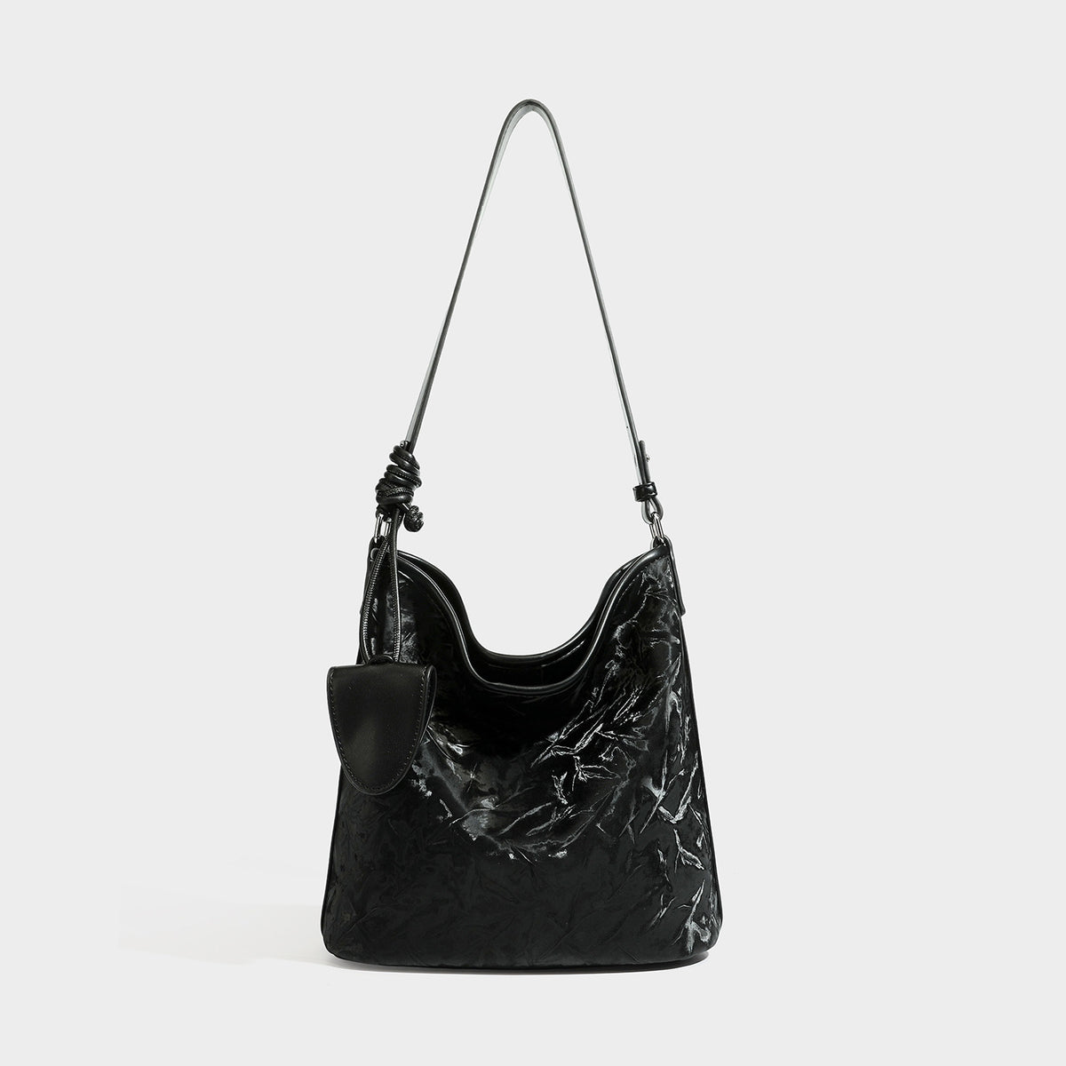 Große Hobo-Schultertasche mit Knitterglanz in tiefem Braun, schmalem verstellbarem Riemen, geknoteten Beschlägen und angesetztem seitlichem Überschlag