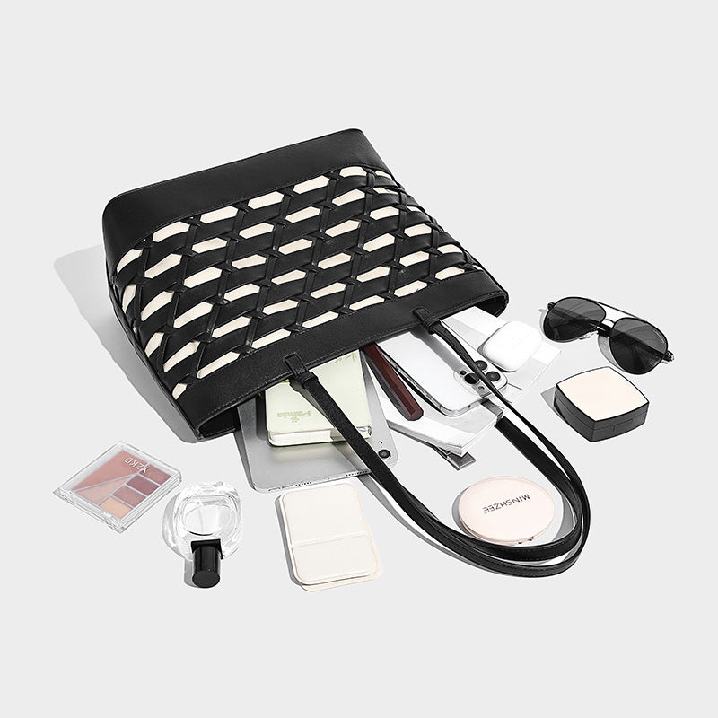 Structured woven lattice cutout tote bag with smooth leather-look trim, dual shoulder straps, and silver-tone hardware
