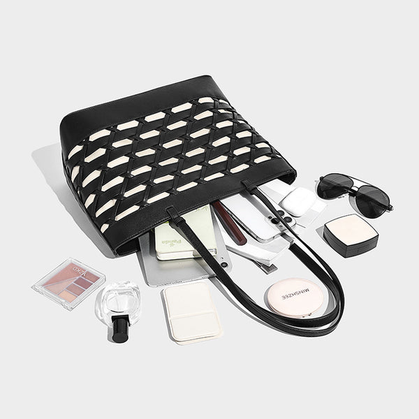 Structured woven lattice cutout tote bag with smooth leather-look trim, dual shoulder straps, and silver-tone hardware