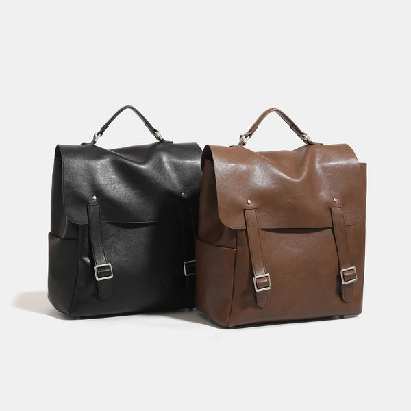 Structured flap backpack handbag in smooth leather-look finish with buckle front pocket, top handle, and silver-tone