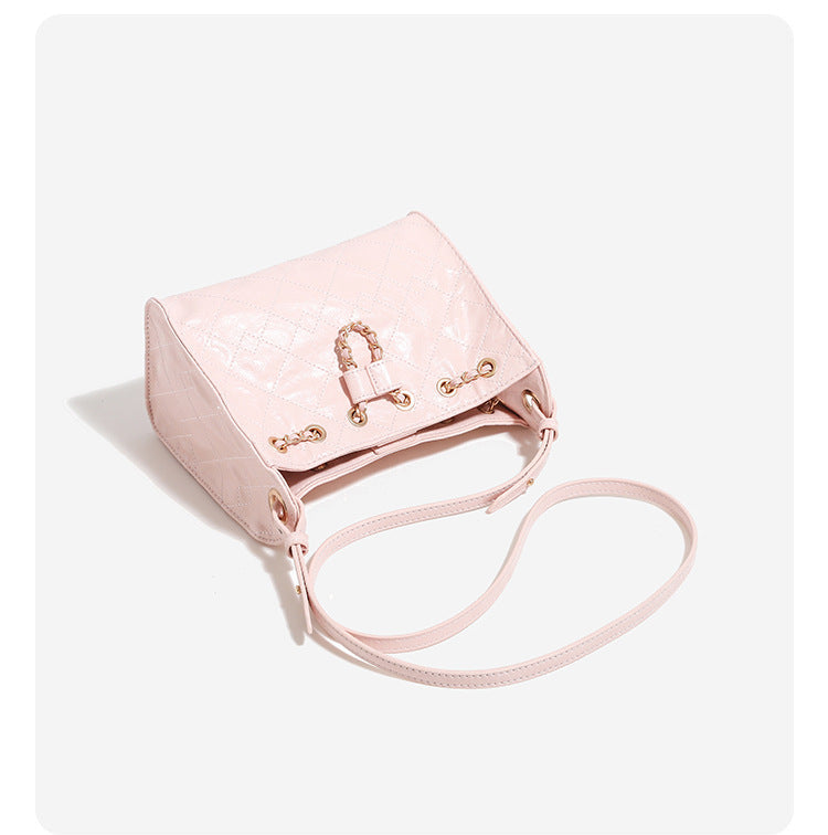 Glossy diamond-quilted drawstring bucket bag with gold-tone chain strap and eyelet hardware, detail view 13