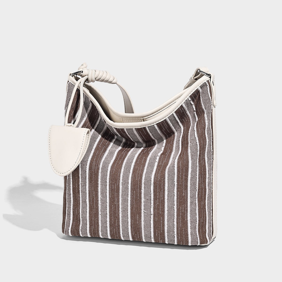 Large striped canvas hobo shoulder bag with cream trim and silver-tone hardware, detail view 6