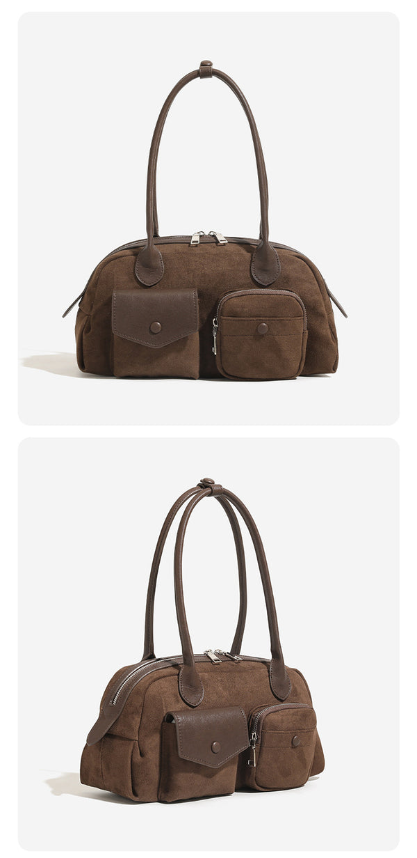 Structured matte leather-look bowling bag with snap-flap and zip front pockets, looped top handles, and antique gold-tone