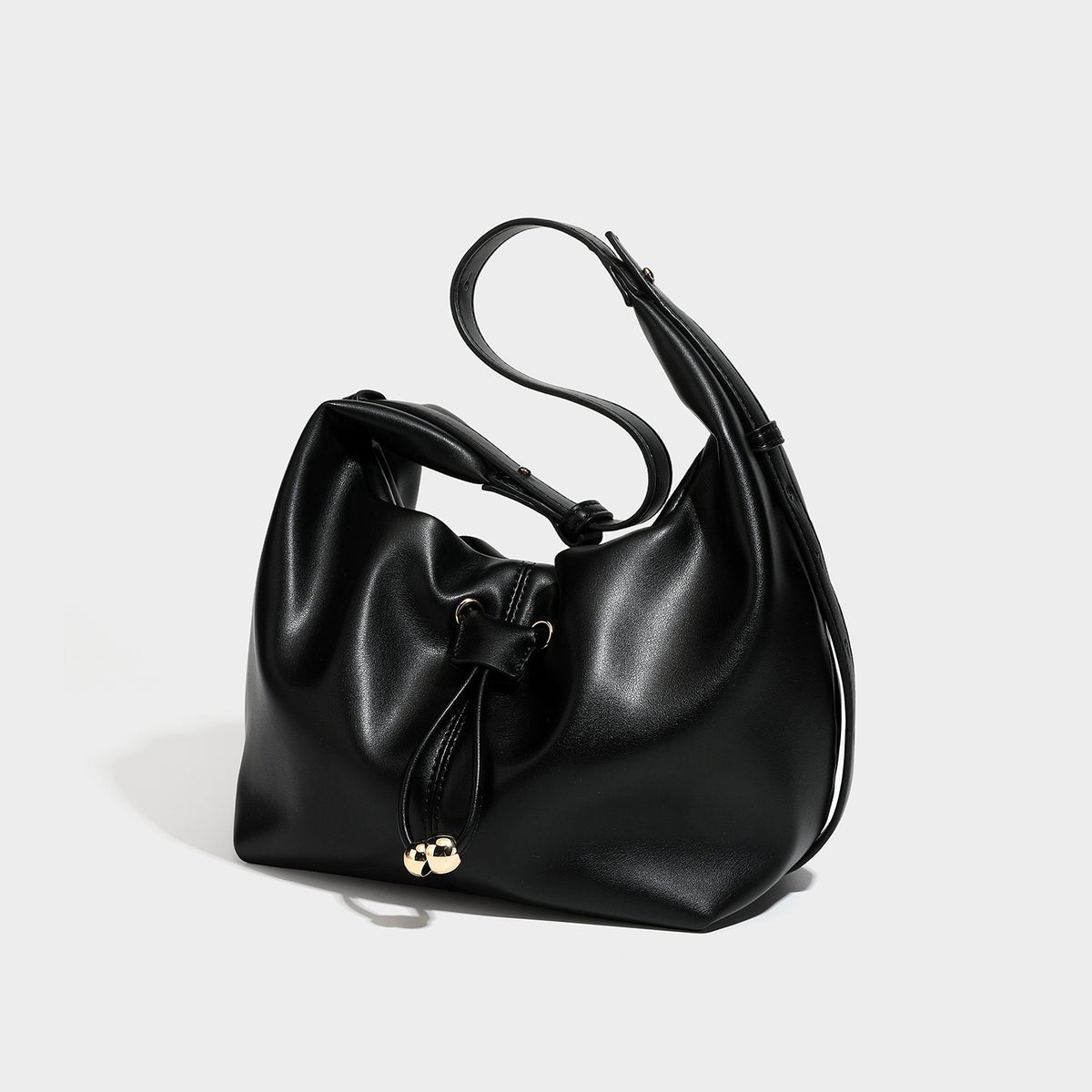 Slouchy hobo bag with smooth leather-look finish, drawstring cinch closure, and gold-tone bead hardware, detail view 4