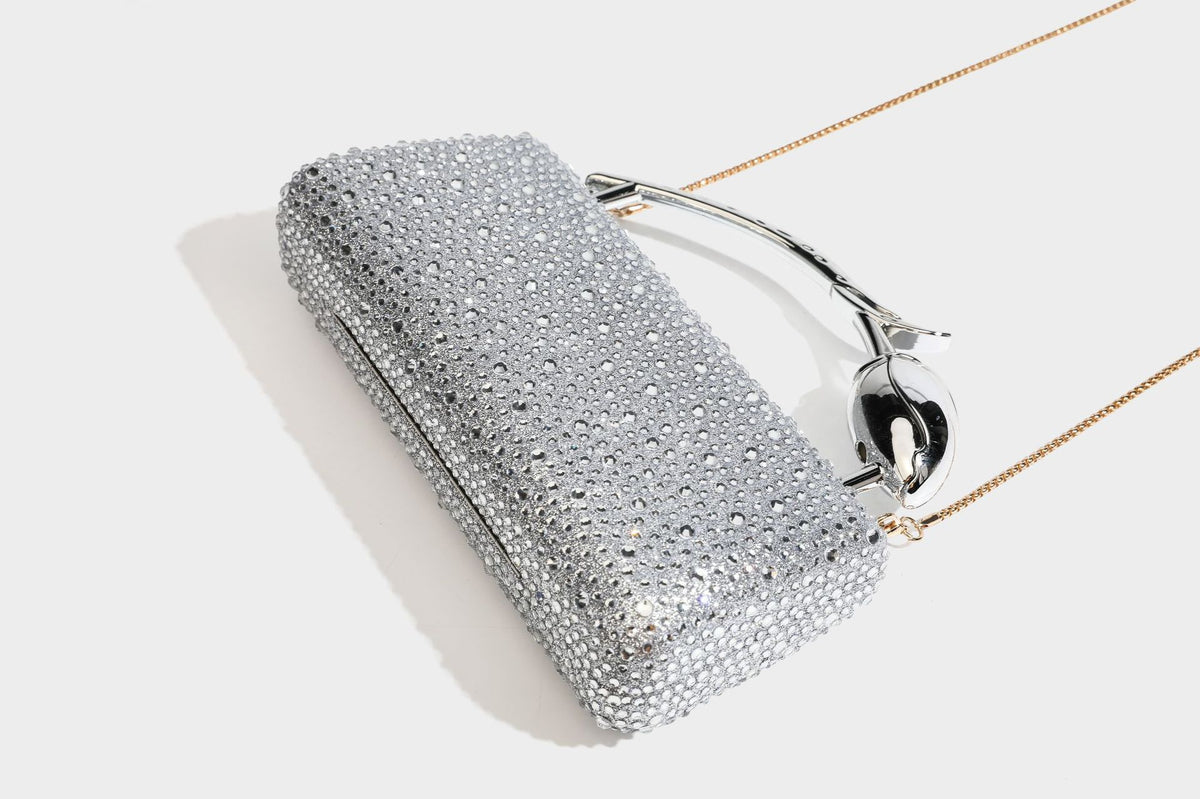 rectangular hard-case rhinestone evening clutch with sculptural gold-tone branch-and-bud top handle and detachable chain