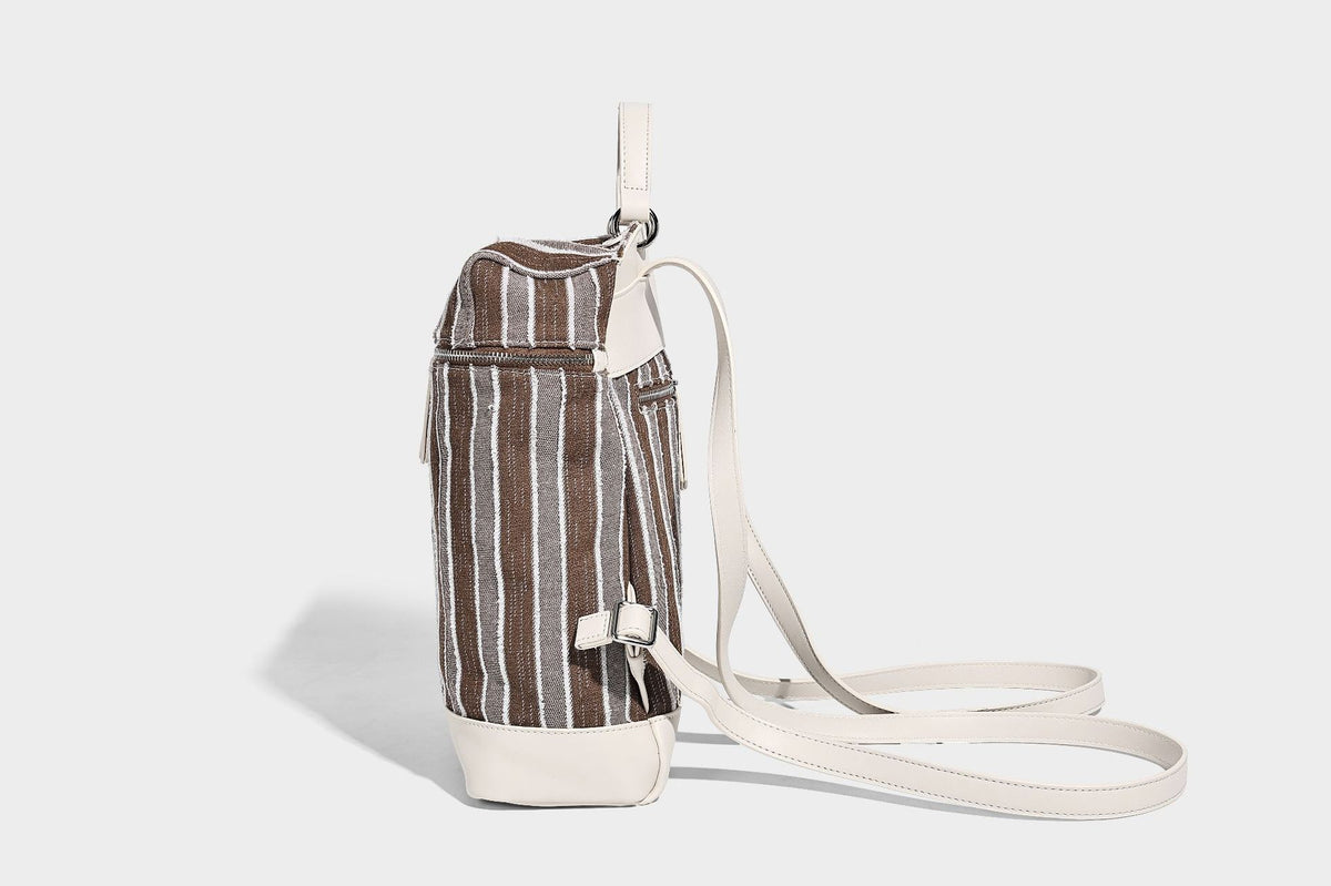 Small structured striped fabric backpack handbag with cream leather-look trim, top handle, and silver-tone hardware, detail