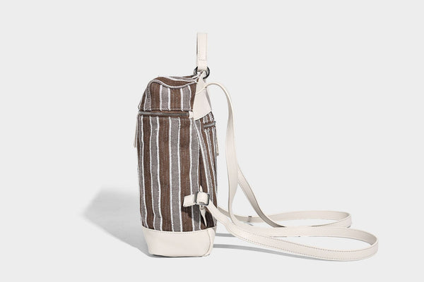 Small structured striped fabric backpack handbag with cream leather-look trim, top handle, and silver-tone hardware, detail