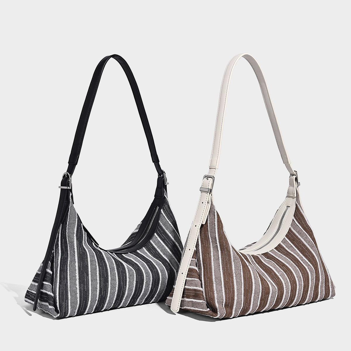 Slouchy striped woven hobo bag with contrast cream trim, top zip closure, and adjustable silver-tone buckle strap, detail