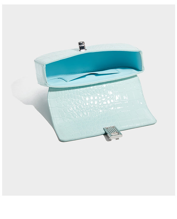 Glossy croc-embossed mini saddle bag with silver-tone turn-lock clasp and short top handle, detail view 15