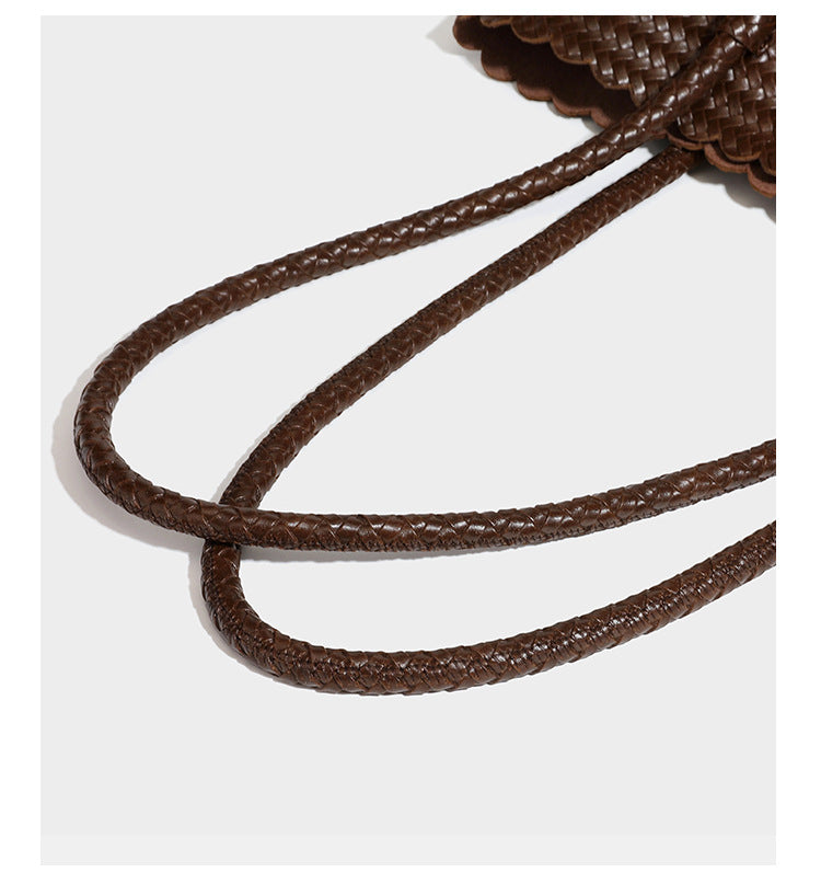 Large open-top woven leather-look tote bag in dark brown with scalloped edge, braided double shoulder straps, and decorative