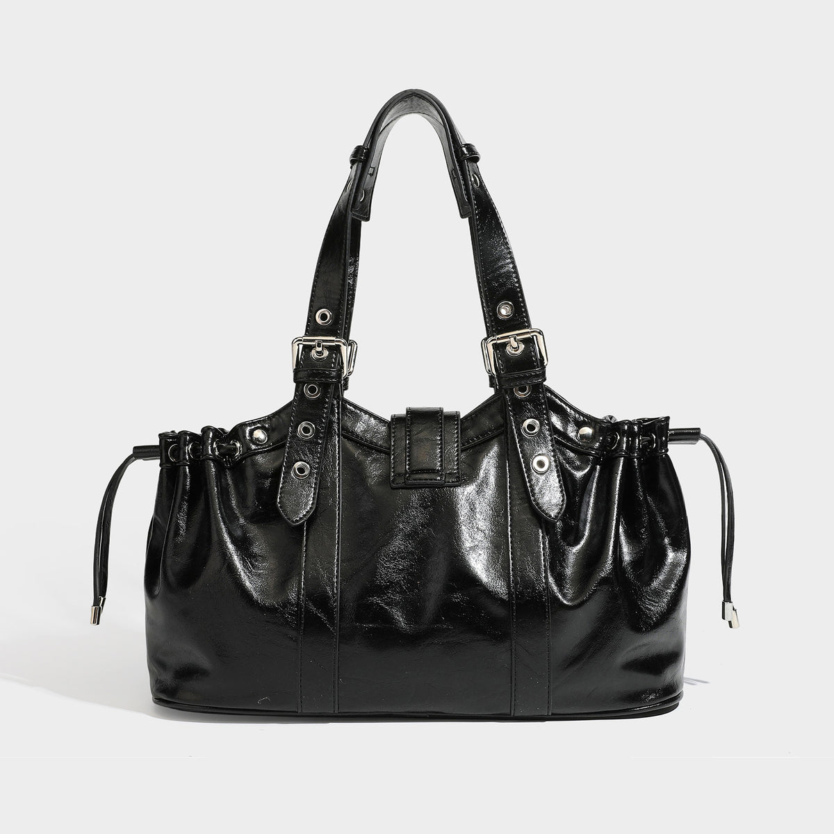 Large black glossy leather-look tote bag with silver buckle straps, eyelet grommet panels, drawstring side gathers, and