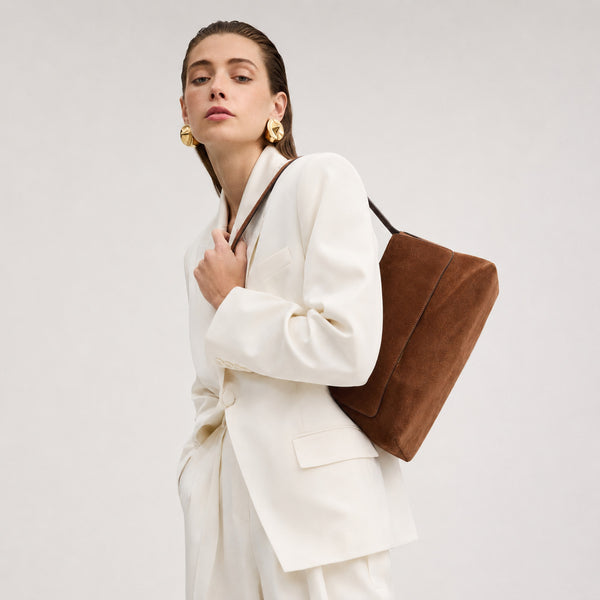 Rectangular matte suede-finish flap shoulder bag with slim dark strap and gold-tone turn-lock hardware, detail view 10
