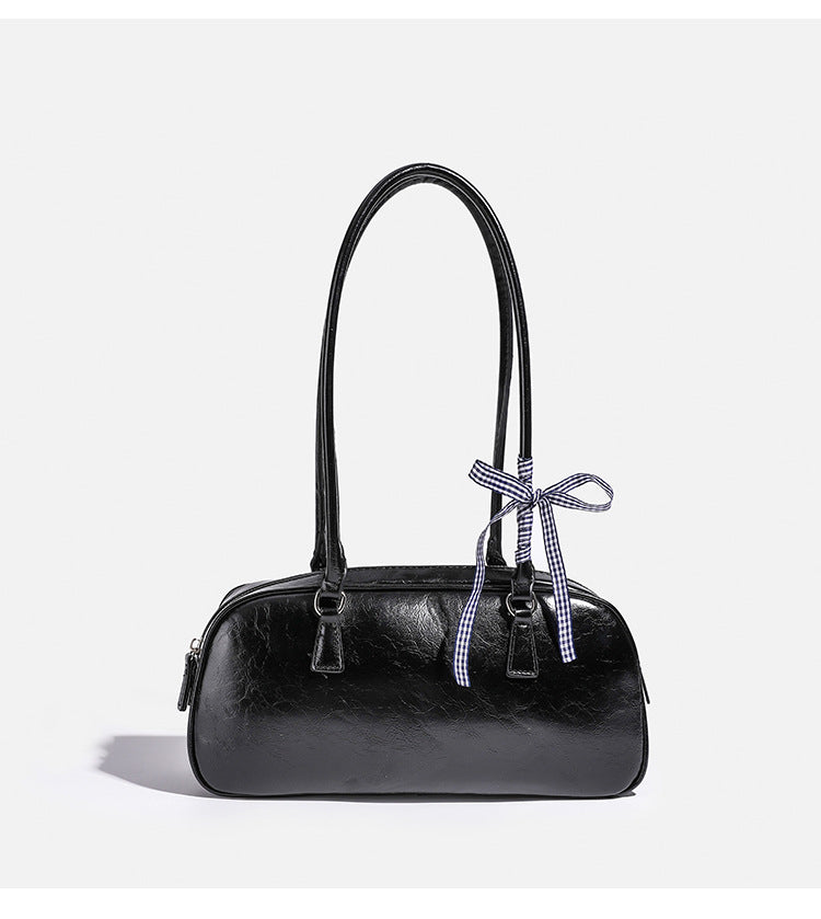 Rounded rectangular shoulder bag with glossy crinkled finish, dual long handles, top zip closure, and gingham ribbon bow