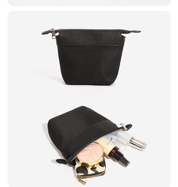 Structured black leather-look bucket tote bag with slim shoulder straps, silver-tone stud hardware, and tapered body, detail