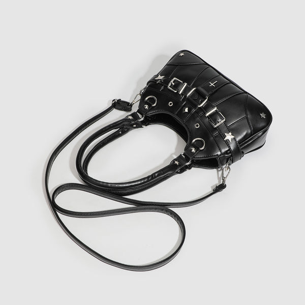 Small structured glossy leather-look crossbody bag with star-stud hardware, buckle strap detail, zip closure, and detachable