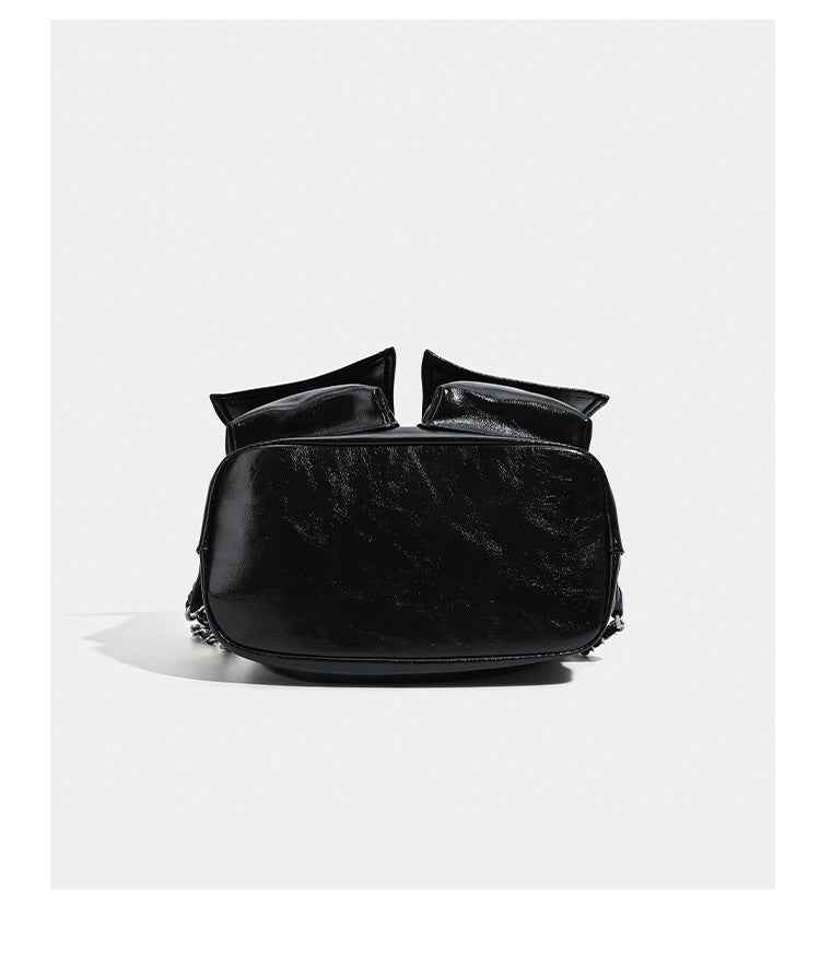 Glossy leather-look drawstring bucket bag with silver dome studs and chain shoulder strap, detail view 14