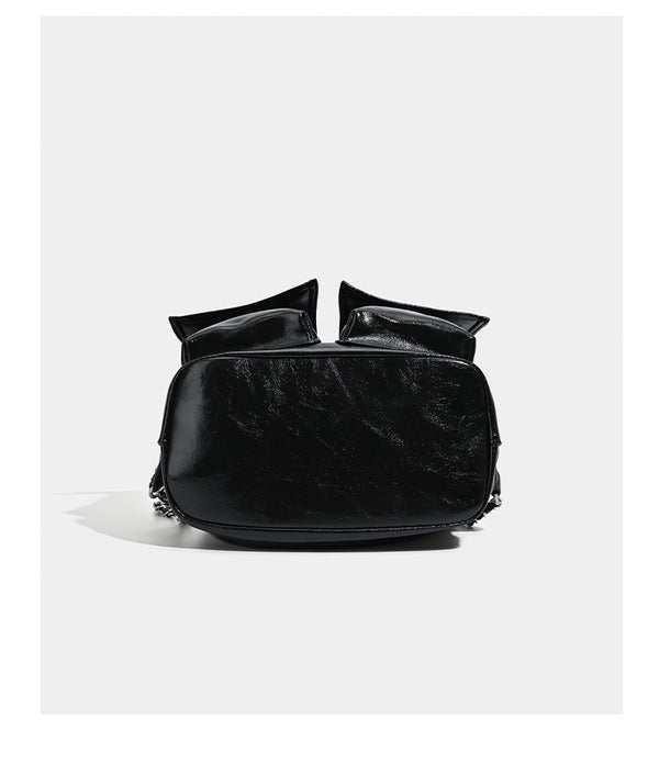 Glossy leather-look drawstring bucket bag with silver dome studs and chain shoulder strap, detail view 14